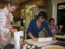 Everyone busy making Lefse, a Norwegian potato tortilla.  It is usually buttered, spiced with sugar and cinnamon, and rolled.  In this picture, Anita is busy balling the potato mash, Jess rolling the balls flat, and Kiersten QC'ing them as they come off the skillet.